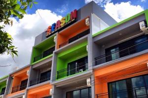 a building with brightly colored balconies on it at The Season Airport Udonthani in Udon Thani