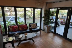 a living room with a couch and a table at The Season Airport Udonthani in Udon Thani