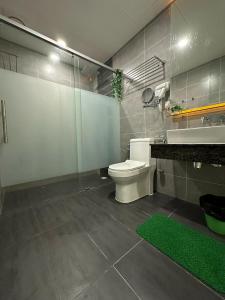 a bathroom with a white toilet and a sink at Premium Family 3BR Genting Ion Delemen in Genting Highlands