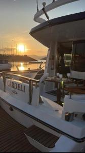 a boat is docked at a dock with the sunset at Hotel Boat Cardeli in Gijón