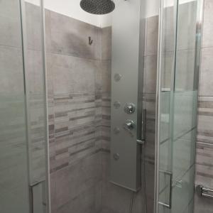 a walk in shower with a glass door at Sweet Home in Torino Cenisia in Turin