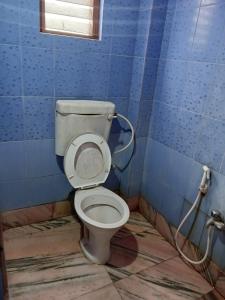 a dirty bathroom with a toilet in a room at HOTEL NAKSHATRA in Digha