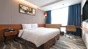 a hotel room with a bed and a desk at Gloucester Hotel Jeonju in Jeonju +29 photos