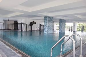 a swimming pool with blue water in a building at Rush Reliance Mt. Lavinia in Attidiya