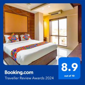 a bedroom with a bed in a room with a window at FabHotel Eros 211 in Kolkata