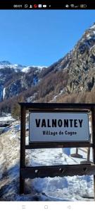 a sign for a valley with a mountain in the background at Grand Rive in Saint-Pierre