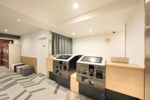 a kitchen with a stove and a counter top at Hotel NewNagano NeXT in Nagano