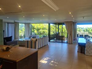 a living room with a view of a living room at Zimbali - Luxury 4 Bedroom KRH1 in Ballito