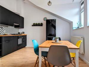 a kitchen and dining room with a table and chairs at Starowiślna 34 by Homeprime in Krakow