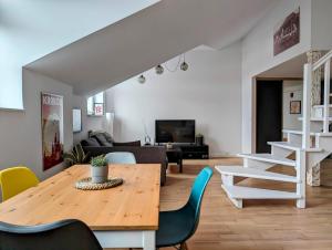 a living room with a wooden table and chairs at Starowiślna 34 by Homeprime in Krakow