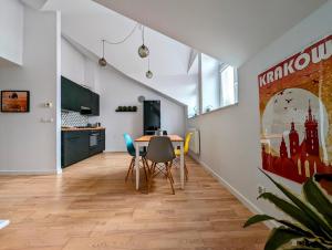 a dining room with a table and chairs at Starowiślna 34 by Homeprime in Krakow