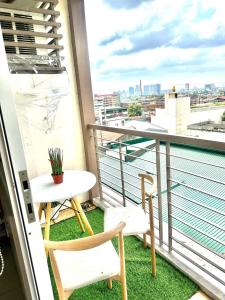 a balcony with a table and chairs and a view at KenZel Staycation in Manila