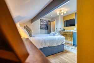 a bedroom with a bed and a kitchen with a sink at Haworth Heights - An AMAZING Aparthotel! in Haworth