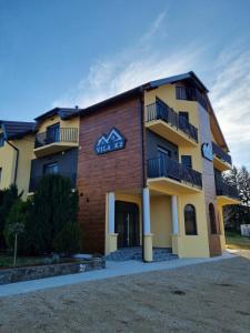 a building with balconies on the side of it at Vila K2 in Vrdnik