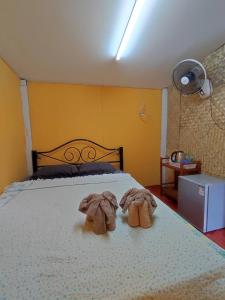 um quarto com uma cama com duas toalhas em BaanNakanoHomestay em Mae Rim