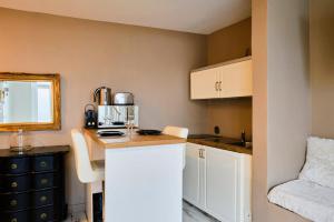 a small kitchen with white cabinets and a counter at One bedroom apartment on the edge of Citadelle in Lille