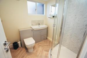a bathroom with a toilet and a sink and a shower at The Stay Company, Friar Gate Bridge. in Derby