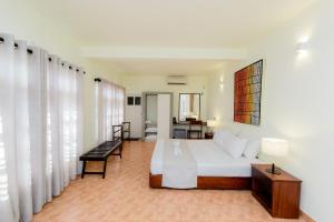 a bedroom with a bed and a living room at Shangrela Beach Resort by ARK in Ambalangoda +193 photos