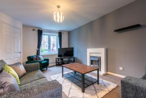 a living room with a couch and a table at 3 Bed Gem in Pontefract for Easy Commutes to Leeds and Wakefield in Pontefract