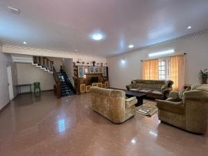 a large living room with two couches and a table at Chill Inn - Families Only in Ooty