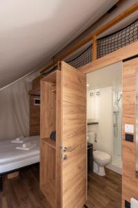 a bathroom with a bunk bed and a toilet at ForRest Glamping in Banská Štiavnica