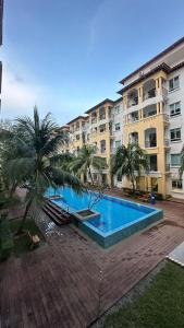 a large swimming pool in front of a building at Desaru Homestay Southern, Tiara Desaru Seaview Residensi in Bandar Penawar