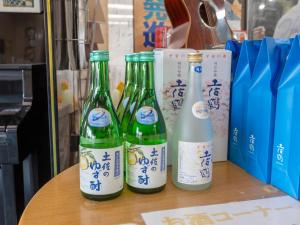 three bottles of wine sitting on top of a table at Kochi Kuroshio Hotel in Konan