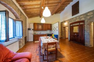 a kitchen with a table in the middle of a room at Agriturismo il Palagetto in Pomarance