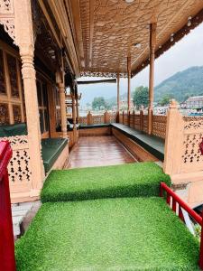 a building with green grass on the side of it at The Hayat Group Of Houseboats in Srinagar