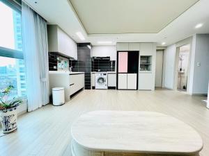a large living room with white cabinets and a table at Super quiet Dry bath floor OLED TV Closet room in Seoul