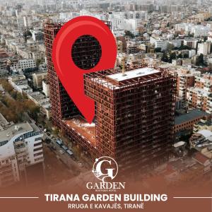 ein Plakat für ein Gebäude mit einem großen roten Symbol in der Unterkunft Garden Boutique Hotel in Tirana