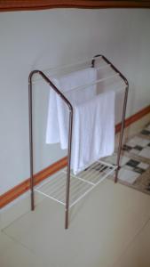 a towel rack with white towels on it at Goa Walet Cottage in Praya