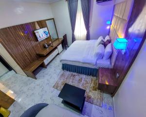 an overhead view of a bedroom with a bed and a television at Chillers Hotel and Suites in Aiyetoto-Asogun