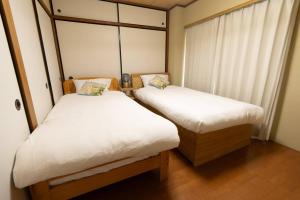 Llit o llits en una habitació de 202号室貸切！2DK/京成佐倉駅徒歩3分・電車成田空港20分・京成上野直結！厨房/風呂/洋室/4名