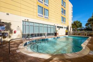 a swimming pool in front of a building at SpringHill Suites Tampa North/Tampa Palms in Tampa