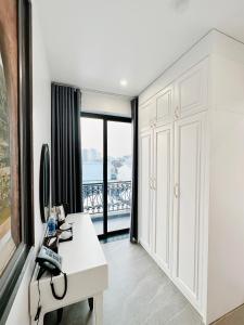 順化的住宿－SALA HOTEL HUE，白色的浴室设有书桌和窗户。