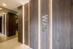 a lobby with a sign on a wooden wall at Hotel Fanat in Split