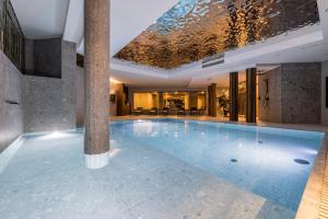 a large swimming pool in a building at Hotel Fanat in Split