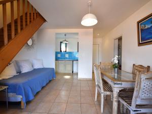 a living room with a bed and a dining room at Résidence Maquis Bella Vista in Propriano