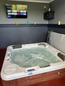 a bath tub filled with water in a room at Portarlington Family Fun House in Portarlington +18 photos