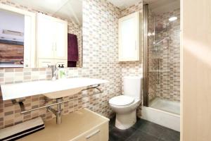a bathroom with a toilet and a sink and a shower at Beachfront and Charming Apartment in Mareny Blau