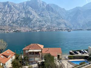 a view of a large body of water with mountains at Blanka Sea View Apartments in Kotor