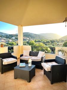 a balcony with couches and a table with a view at Casa Carmen - Attico vista mare in Porto San Paolo