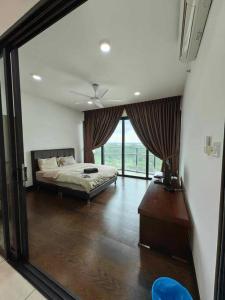 a bedroom with a bed and a large window at Almas Suites Netflix Wifi Puteri Harbour By STAY in Nusajaya +45 photos