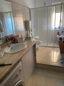 a bathroom with a sink and a toilet and a shower at Frontemare in Crotone
