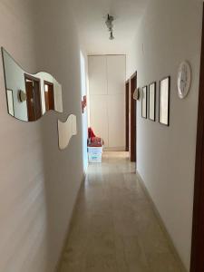 a hallway with two mirrors on a white wall at Frontemare in Crotone