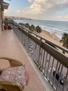 a balcony with a table and chairs and the beach at Frontemare in Crotone