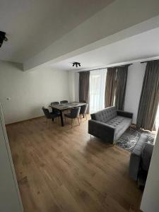 a living room with a couch and a table at Apartament Szary 14/2 in Starogard Gdański