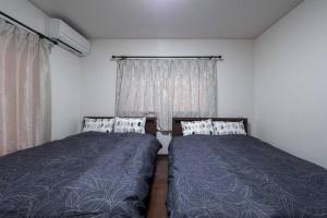 Una cama o camas en una habitación de 焼肉台付き &箱根仙石原を大勢で遊びたい &癒されたい