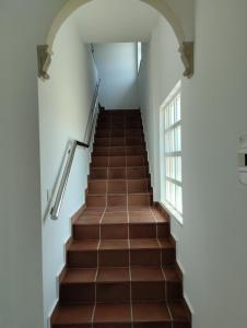 a staircase in a building with brown tiles at CASA Beirada Monte y Playa in Carnota